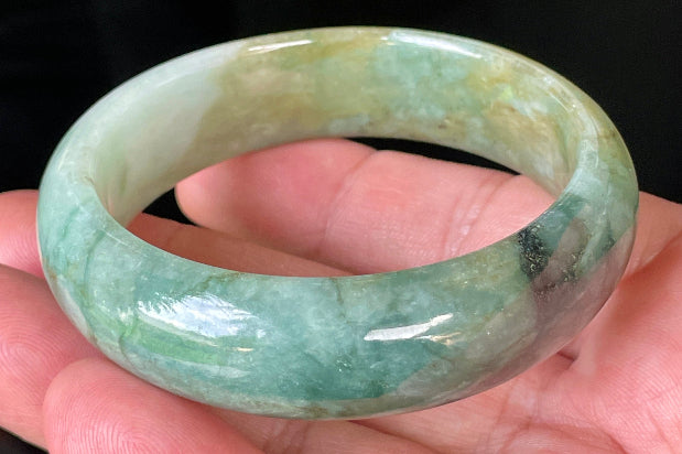 Close-up of fine crystalline texture and natural jade veins on icy bluish apple green jadeite bangle