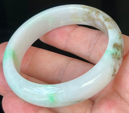 Close-up of fine crystalline texture and imperial green veins on icy milky white jadeite bangle