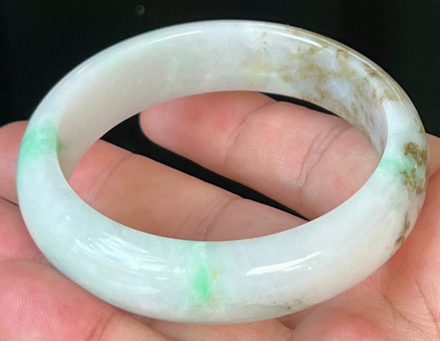 Close-up of fine crystalline texture and imperial green veins on icy milky white jadeite bangle