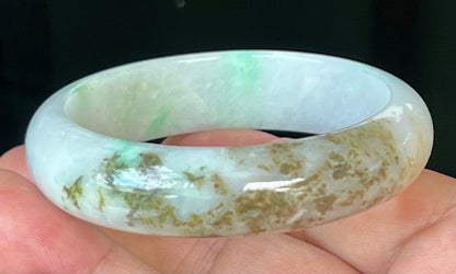 Close-up of fine crystalline texture and imperial green veins on icy milky white jadeite bangle