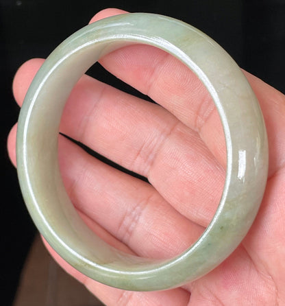 Close-up of fine crystalline texture and moss-in-the-snow effect on icy apple green jadeite bangle
