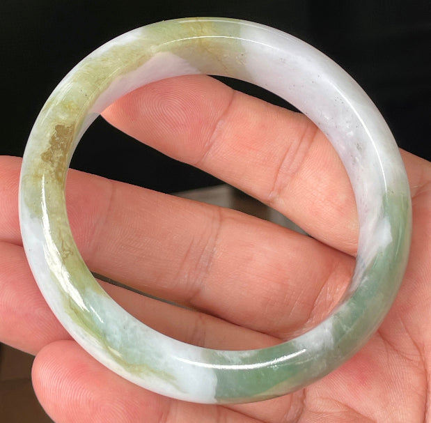 Close-up of fine crystalline texture and moss in the snow pattern on icy greyish white jadeite bangle