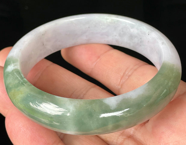Close-up of fine crystalline texture and moss in the snow pattern on icy greyish white jadeite bangle
