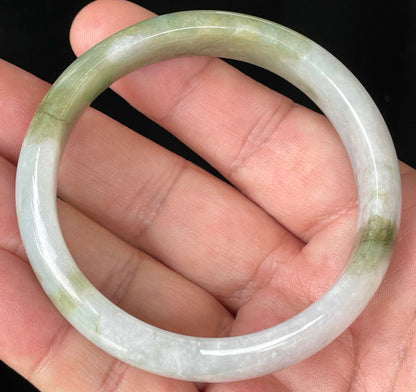 Close-up of fine crystalline texture and moss in the snow effect on icy greyish white jadeite bangle
