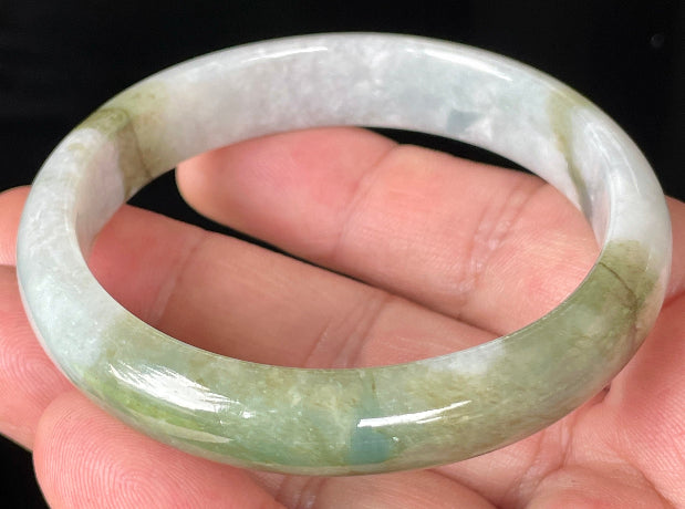 Close-up of fine crystalline texture and moss in the snow effect on icy greyish white jadeite bangle