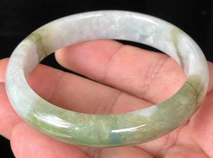 Close-up of fine crystalline texture and moss in the snow effect on icy greyish white jadeite bangle