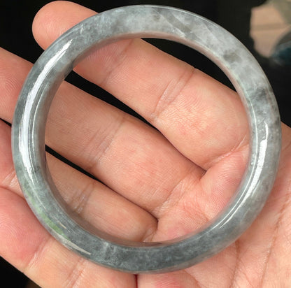 Close-up of fine crystalline texture and subtle honey hues on icy grey jadeite bangle