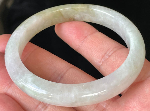 Close-up of fine crystalline texture and subtle natural jade veins on icy milky white jadeite bangle