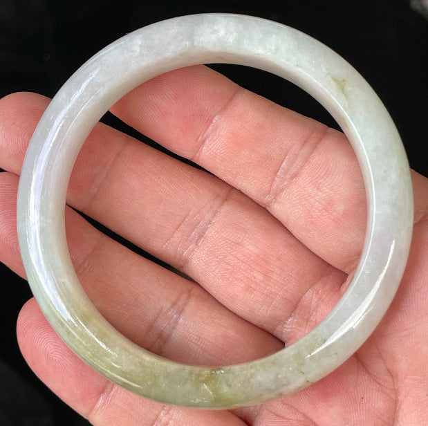 Close-up of fine crystalline texture and subtle natural jade veins on icy milky white jadeite bangle