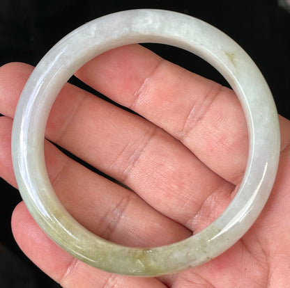 Close-up of fine crystalline texture and subtle natural jade veins on icy milky white jadeite bangle