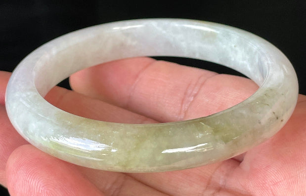 Close-up of fine crystalline texture and subtle natural jade veins on icy milky white jadeite bangle