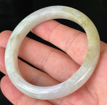 Close-up of fine crystalline texture and subtle natural jade veins on icy milky white jadeite bangle