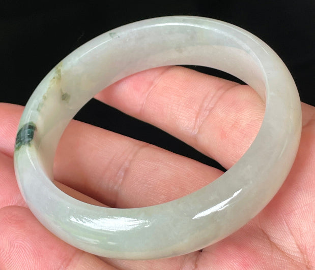Close-up of fine crystalline texture and icy light apple green hues on jadeite bangle