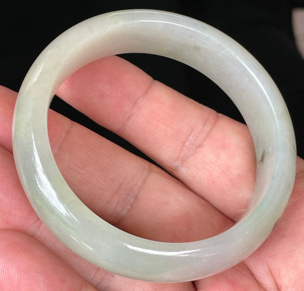 Close-up of fine crystalline texture and icy light apple green hues on jadeite bangle