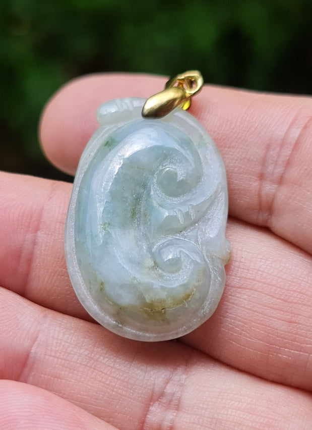 Untreated Type A Burmese jade pendant showing smooth soft sheen with a serene bluish milky white and moss green tone