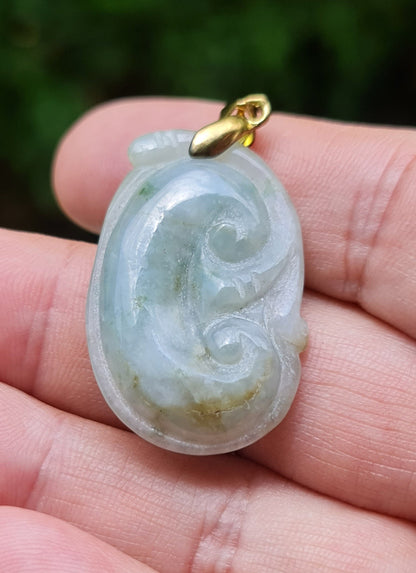 Untreated Type A Burmese jade pendant showing smooth soft sheen with a serene bluish milky white and moss green tone