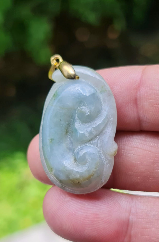 Untreated Type A Burmese jade pendant showing smooth soft sheen with a serene bluish milky white and moss green tone