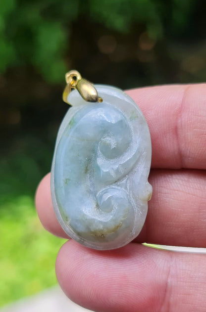 Untreated Type A Burmese jade pendant showing smooth soft sheen with a serene bluish milky white and moss green tone