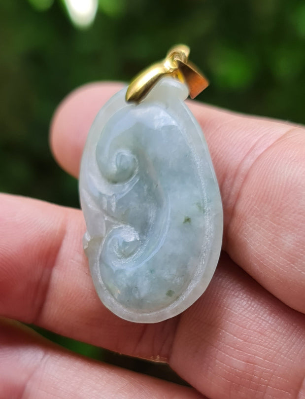 Untreated Type A Burmese jade pendant showing smooth soft sheen with a serene bluish milky white and moss green tone
