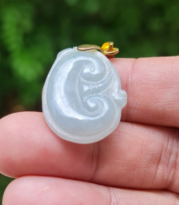 Untreated Type A Burmese jade pendant showing smooth polished luster with a tranquil icy light bluish tone