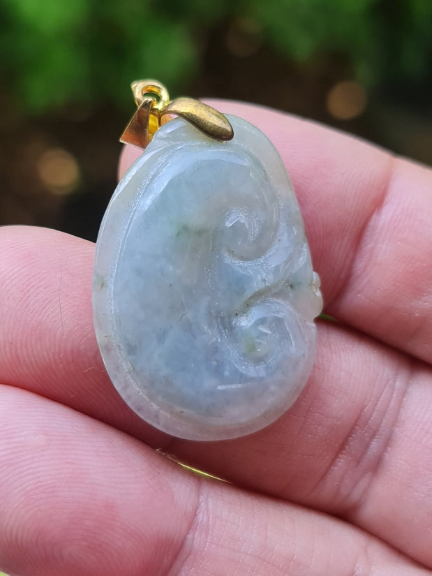 Untreated Type A Burmese jade pendant showing soft luster with a tranquil icy bluish moss green tone