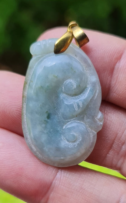 Untreated Type A Burmese jade pendant showing soft luster with a misty icy bluish moss green tone