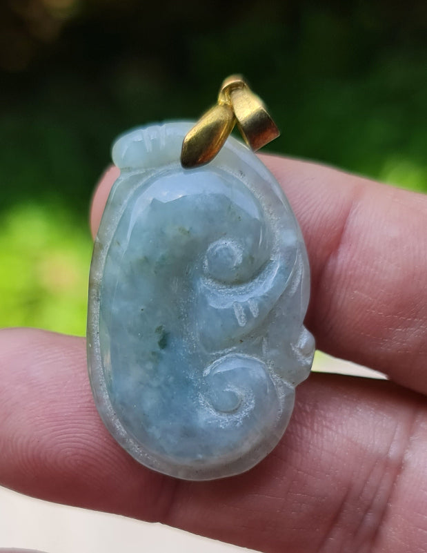 Untreated Type A Burmese jade pendant showing soft luster with a misty icy bluish moss green tone