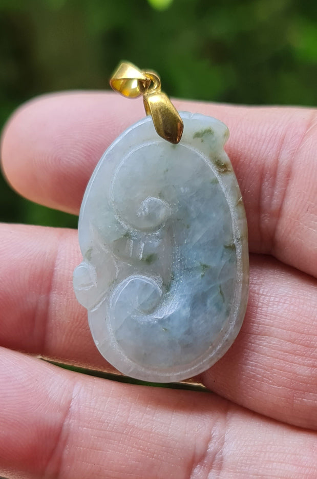 Untreated Type A Burmese jade pendant showing soft luster with a misty icy bluish moss green tone