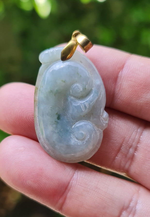 Untreated Type A Burmese jade pendant showing soft luster with a misty icy bluish moss green tone