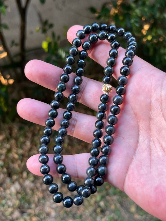 Close-up of 7.3mm Certified Grade A Burmese jadeite beads featuring beautiful icy deep forest and apple green hues, item JN095