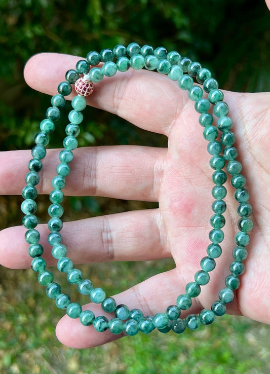 Close-up of 5.9mm Certified Grade A Burmese jadeite beads featuring beautiful icy imperial and apple green hues, item JN076