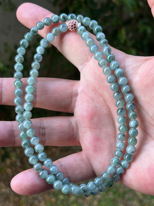 Close-up of 5.9mm Certified Grade A Burmese jadeite beads featuring beautiful icy imperial and apple green hues, item JN078