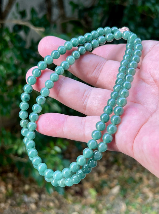 Close-up of 6.2mm Certified Grade A Burmese jadeite beads featuring beautiful icy imperial and apple green hues, item JN073