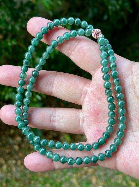 Close-up of 6.2mm Certified Grade A Burmese jadeite beads featuring beautiful icy imperial and apple green hues, item JN074