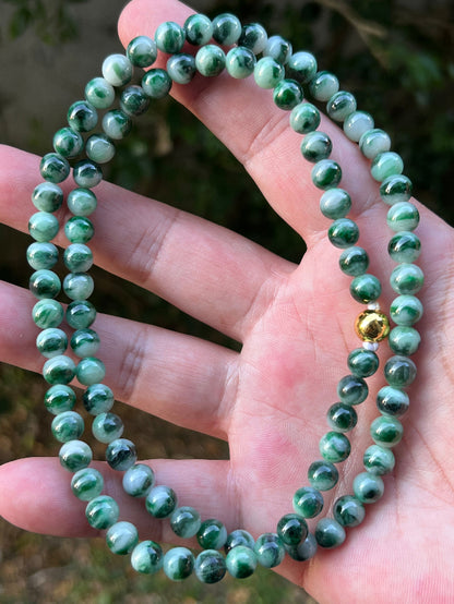 Close-up of 6.8mm Certified Grade A Burmese jadeite beads featuring beautiful icy imperial and apple green hues, item JN087