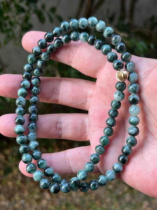 Close-up of 7.2mm Certified Grade A Burmese jadeite beads featuring beautiful icy imperial and apple green hues, item JN086