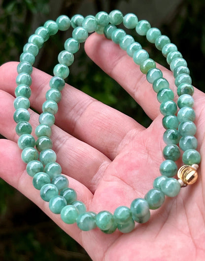 Continuous circle of perfectly round icy white and green genuine Grade A Burmese jadeite beads