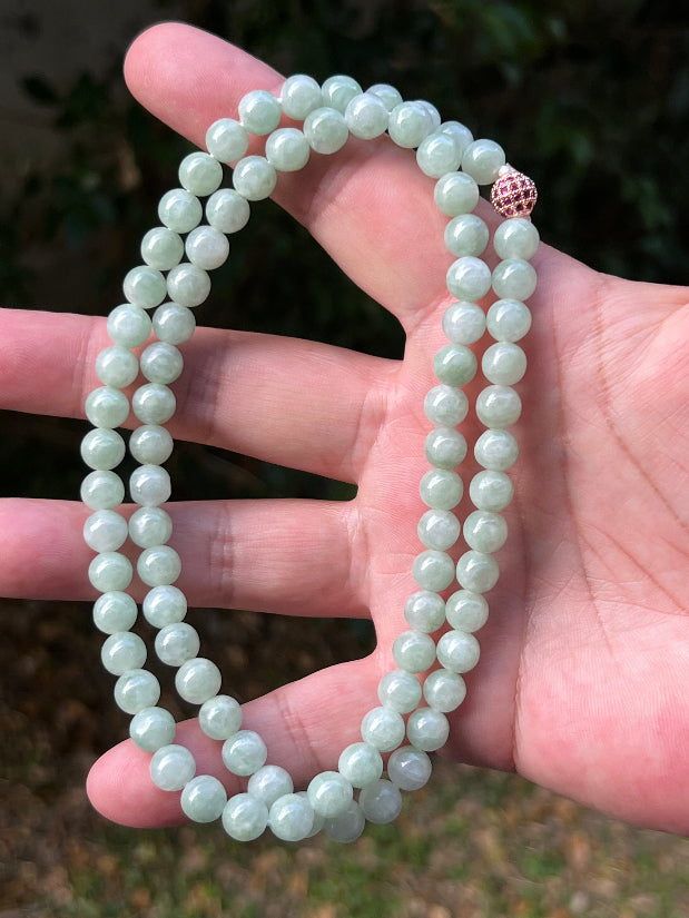 Close-up of 7.5mm Certified Grade A Burmese jadeite beads featuring beautiful icy imperial and apple green hues, item JN081