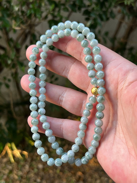 Close-up of 7mm Certified Grade A Burmese jadeite beads featuring beautiful icy imperial and apple green hues, item JN093