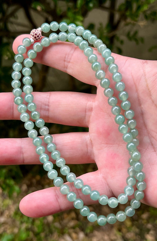 Close-up of 6.2mm Certified Grade A Burmese jadeite beads featuring beautiful icy imperial white and apple green hues, item JN008