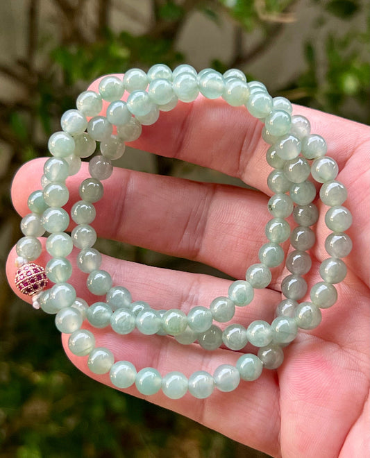 Close-up of 6.2mm Certified Grade A Burmese jadeite beads featuring beautiful icy imperial white and apple green hues, item JN009