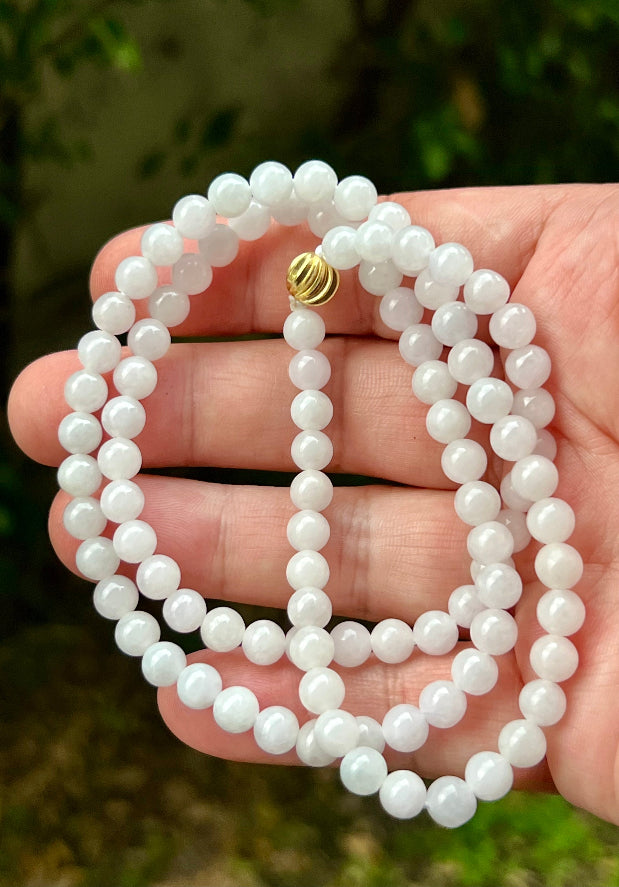 Continuous circle of perfectly round icy white and light green genuine Grade A Burmese jadeite beads