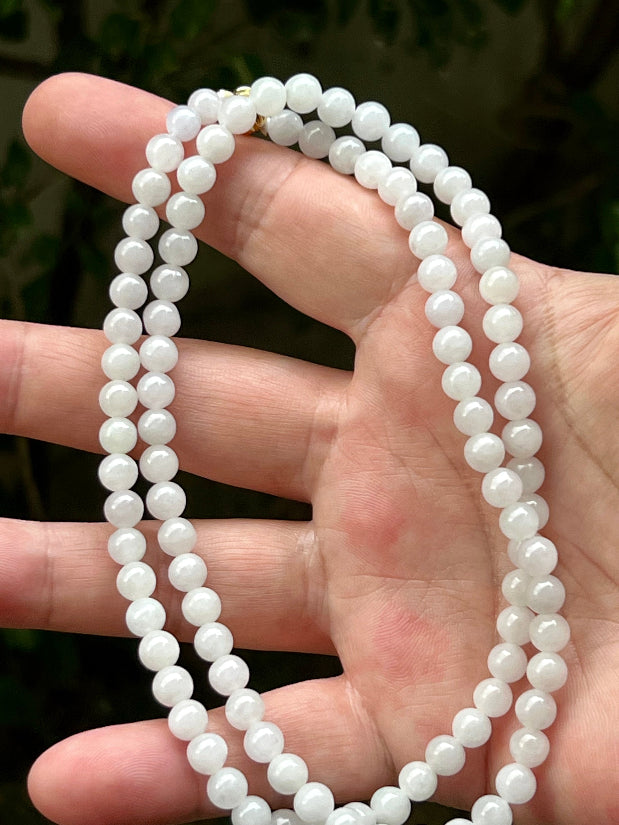 Continuous circle of perfectly round icy white and light green genuine Grade A Burmese jadeite beads