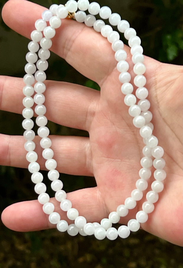 Continuous circle of perfectly round icy white and light green genuine Grade A Burmese jadeite beads