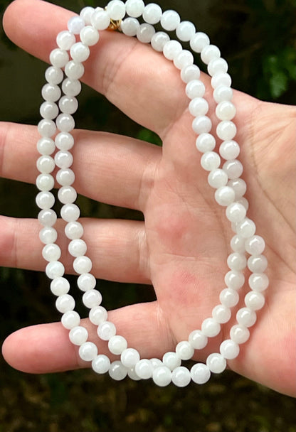 Continuous circle of perfectly round icy white and light green genuine Grade A Burmese jadeite beads
