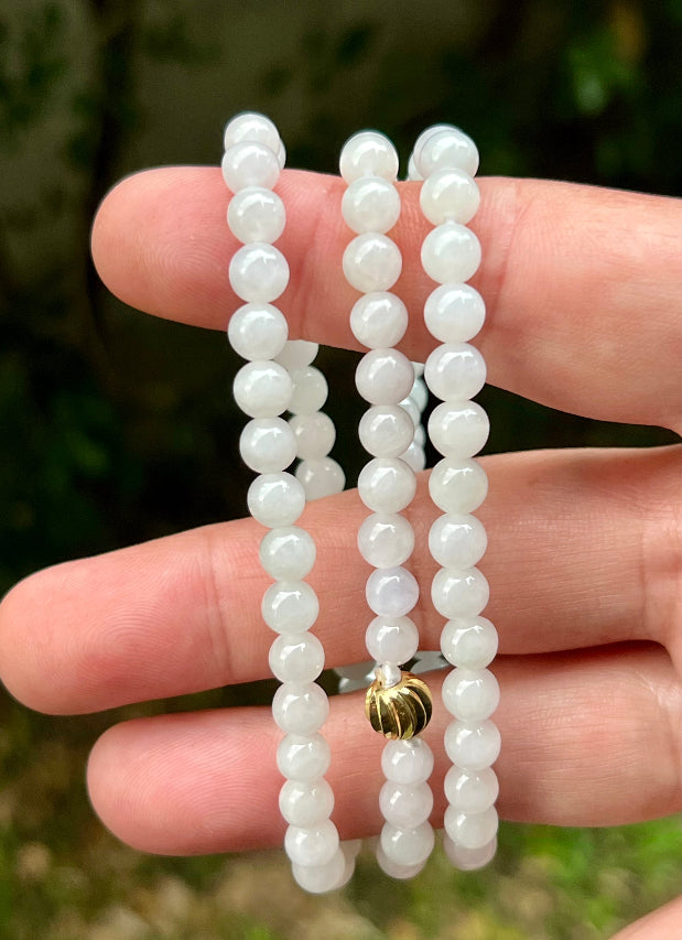 Continuous circle of perfectly round icy white and light green genuine Grade A Burmese jadeite beads