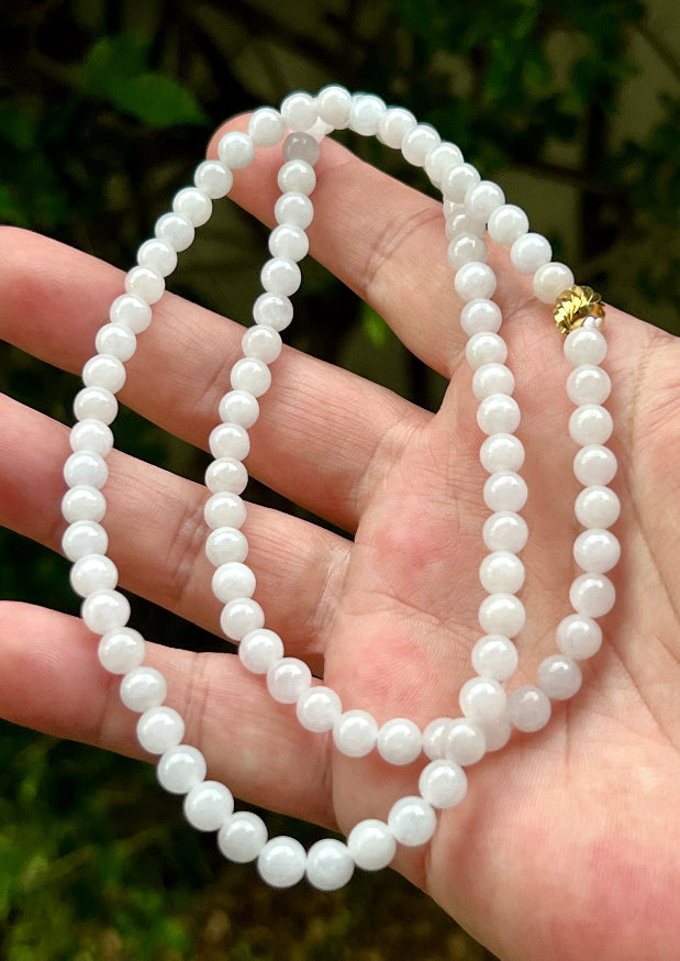 Continuous circle of perfectly round icy white and light green genuine Grade A Burmese jadeite beads