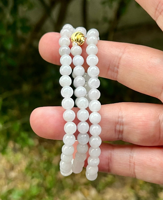 Continuous circle of perfectly round icy white and light green genuine Grade A Burmese jadeite beads