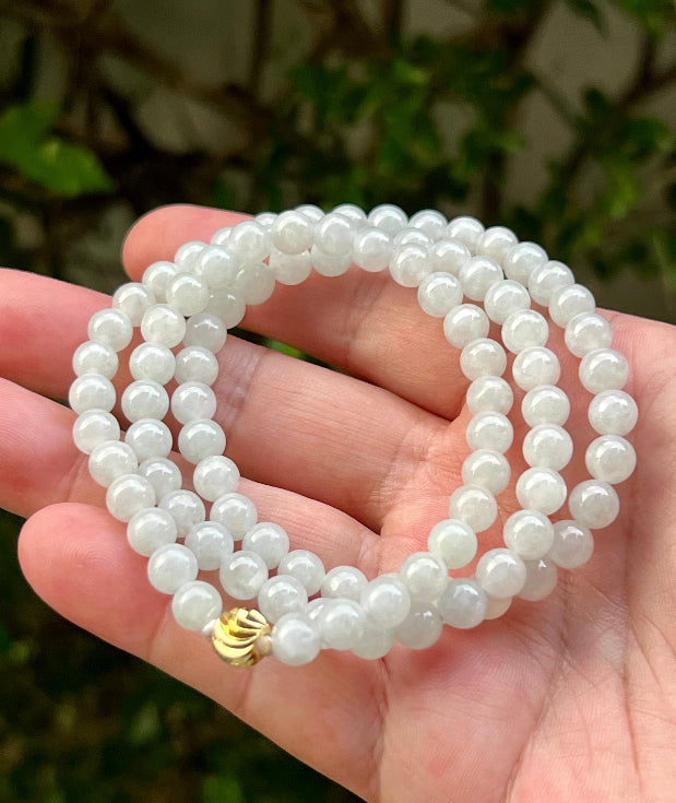Continuous circle of perfectly round icy milky white and light apple green genuine Grade A Burmese jadeite beads