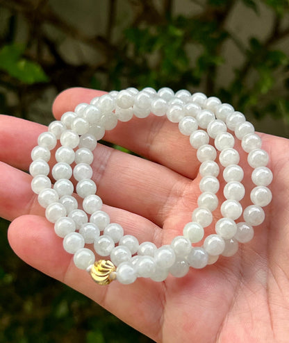 Continuous circle of perfectly round icy milky white and light apple green genuine Grade A Burmese jadeite beads